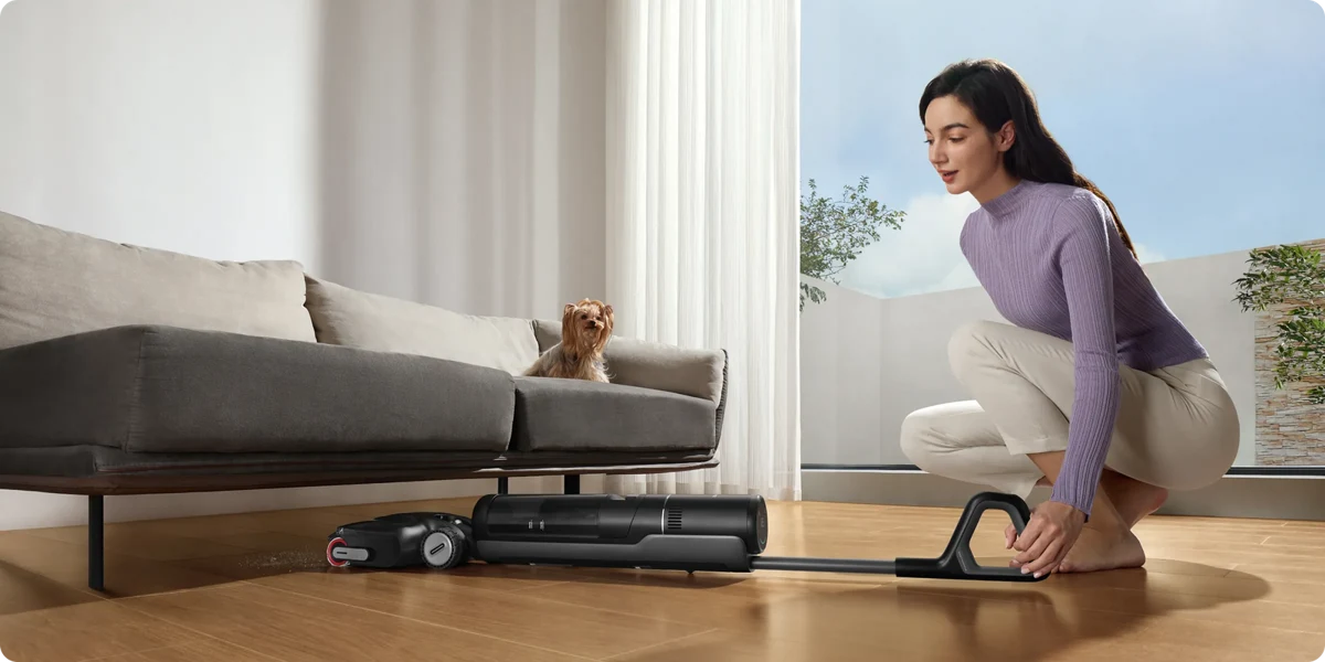 Dreame H12 Pro FlexReach incliné sous un canapé dans un salon